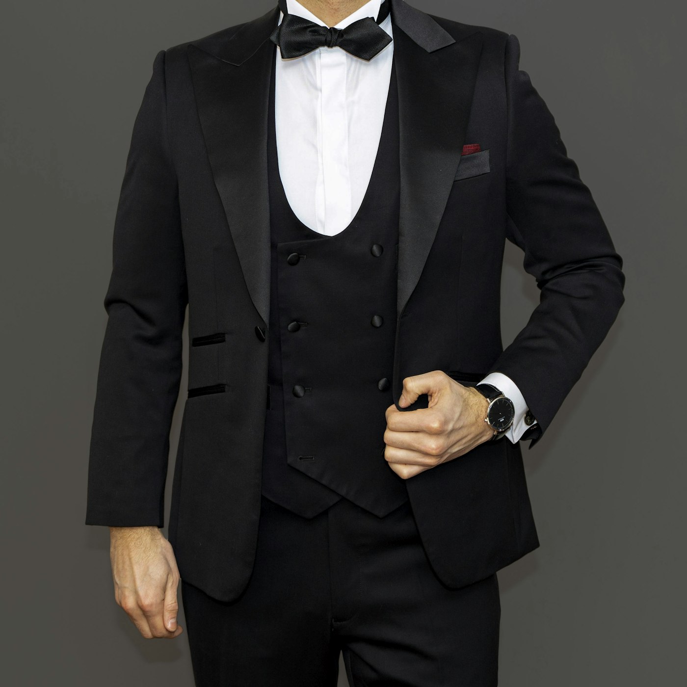 Man wearing a black tuxedo with a bow tie