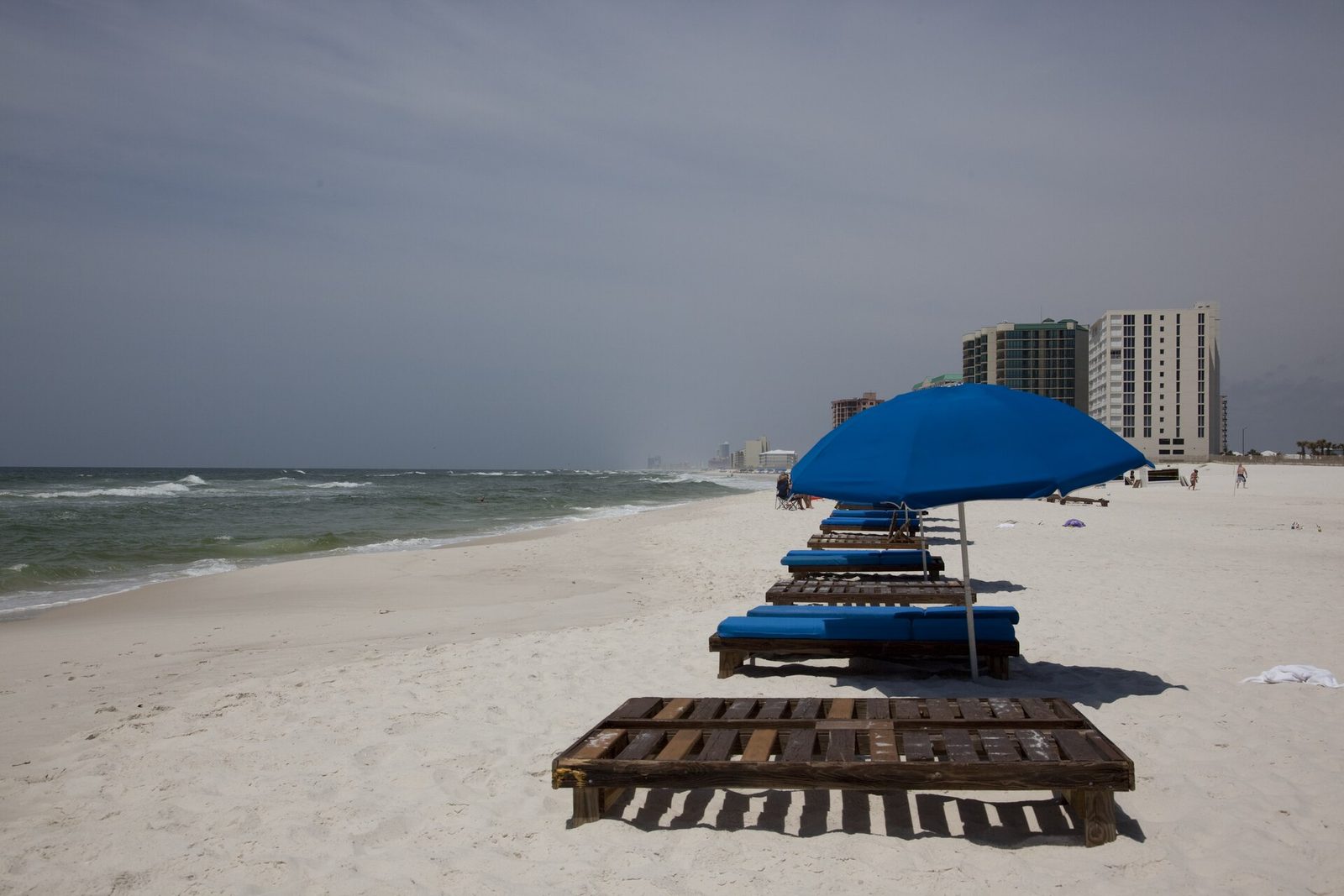 Beach chairs and an umbrella on the white sand in Orange Beach, Alabama