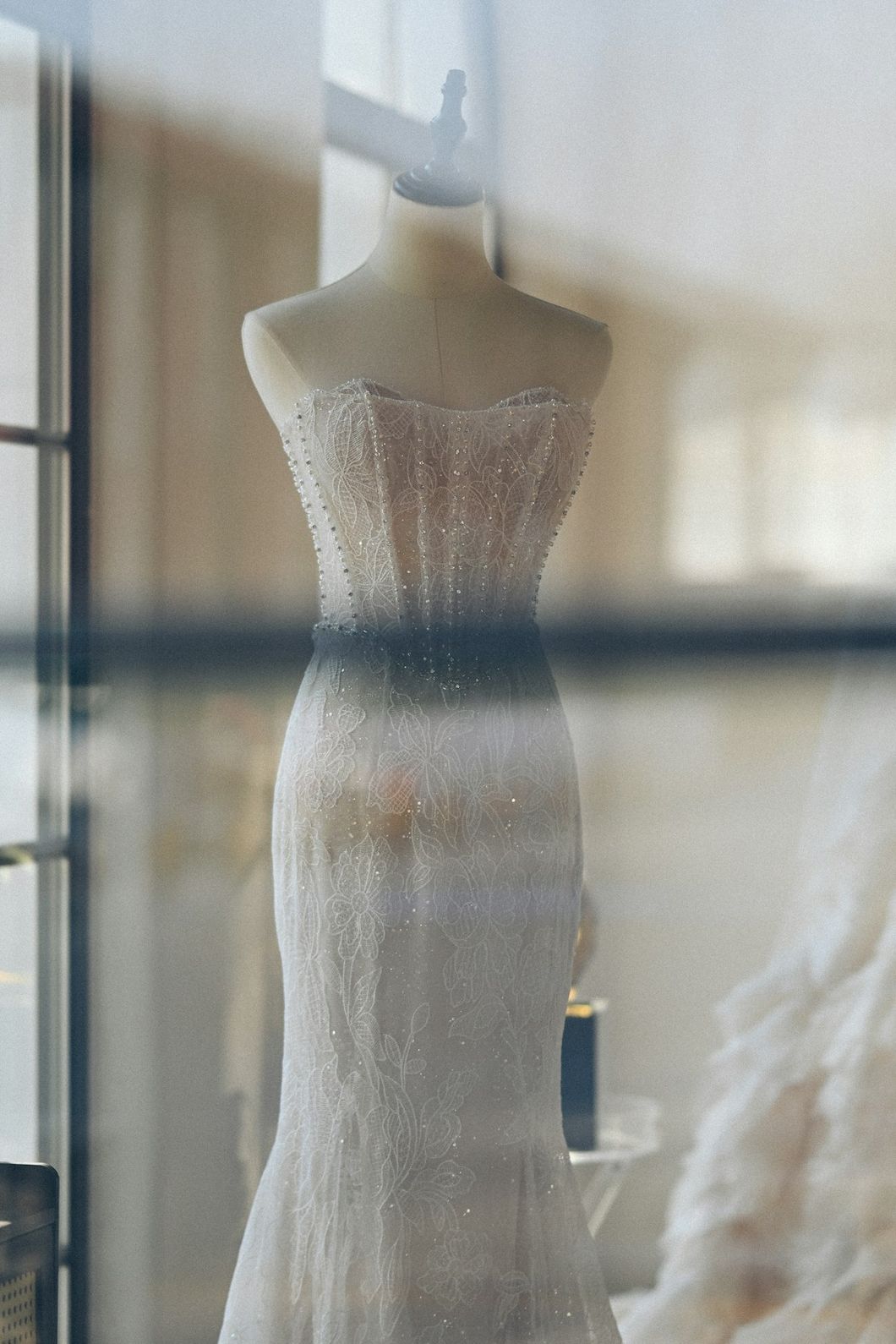 Strapless white wedding gown on a dress form